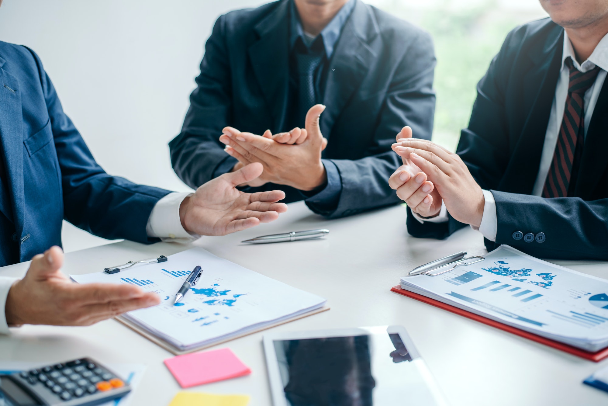 Successful team businessman clapping at meeting.