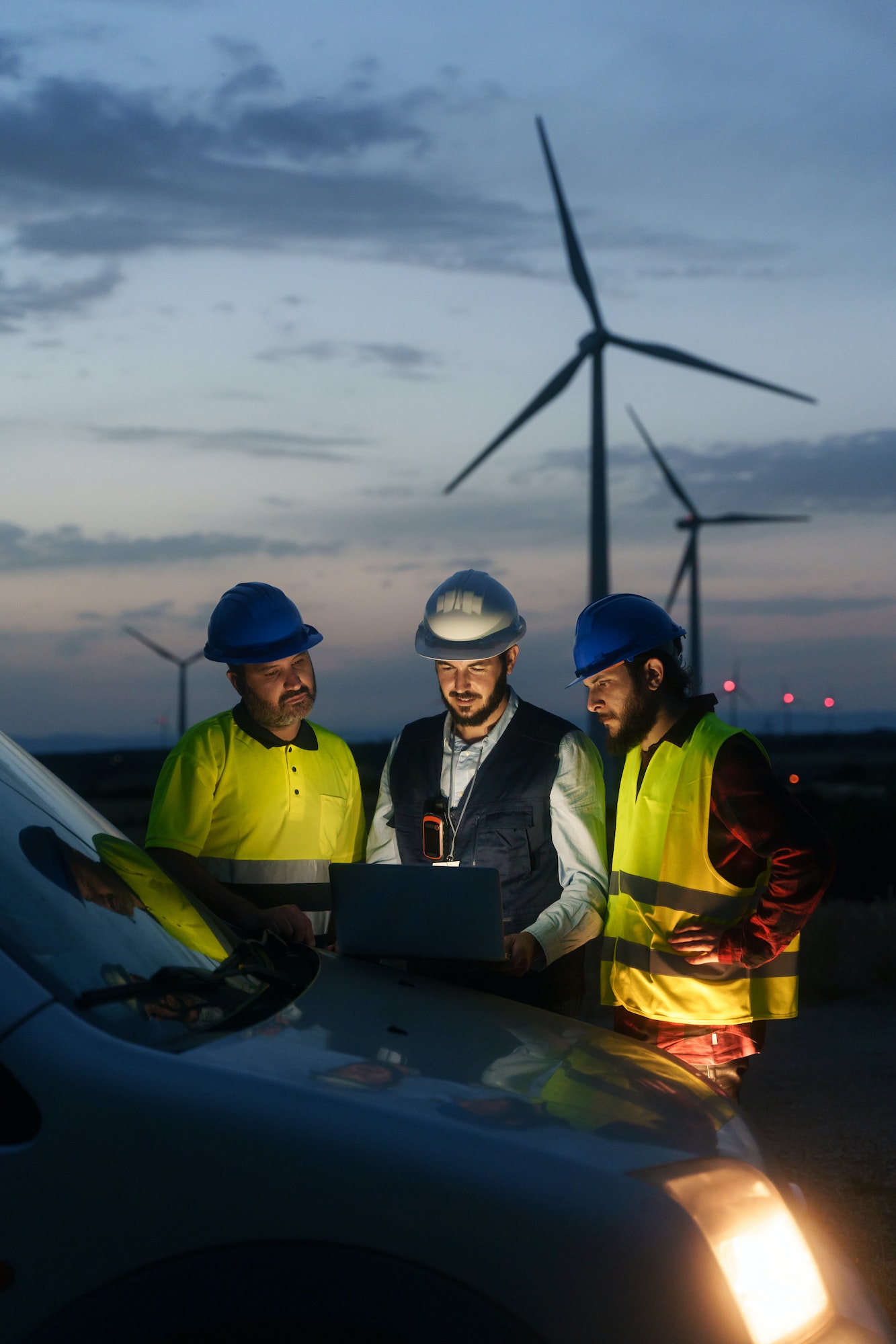 Team of technician and engineer working in wind turbine, planing renewable energy ecology project