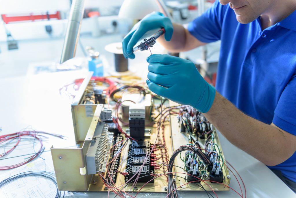 Worker assembling electronics in electronics factory